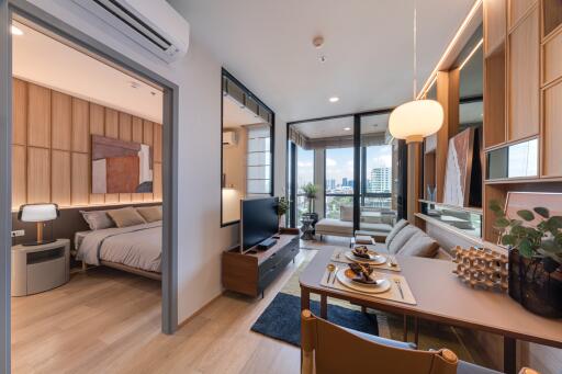 Modern living room with open view, adjoining bedroom, dining area, and balcony.