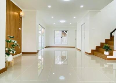 Spacious living room with modern lighting and stairway