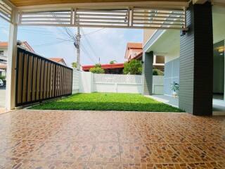 View of front yard with tiled flooring and grass lawn