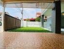 View of front yard with tiled flooring and grass lawn