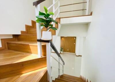 Modern staircase with wooden steps and white railings