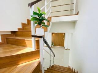 Modern staircase with wooden steps and white railings