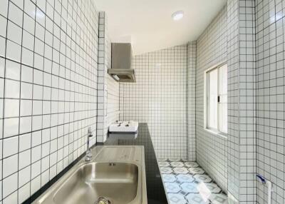 Modern tiled kitchen with black countertop