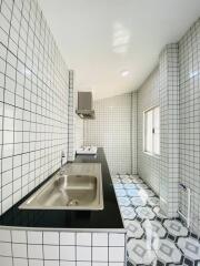 Modern tiled kitchen with black countertop