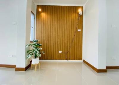 Modern living area with wooden accent wall and plant