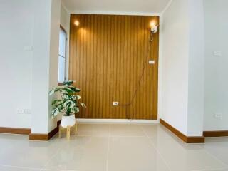 Modern living area with wooden accent wall and plant