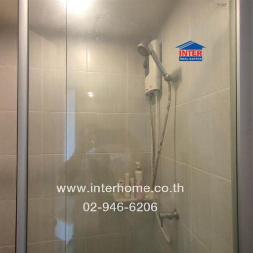 Modern bathroom shower area with a glass door