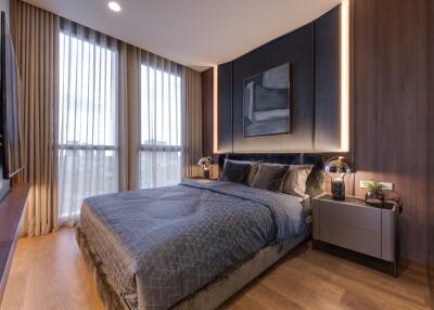 Modern and cozy bedroom with a large bed, stylish decor, and large windows allowing ample natural light