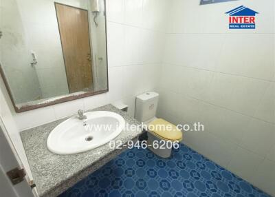 Bathroom with sink, toilet, and mirror