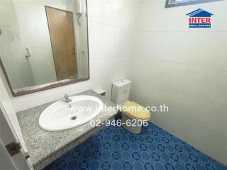 Bathroom with sink, toilet, and mirror