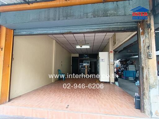 Vacant Garage Space with Rolling Doors and Interior View