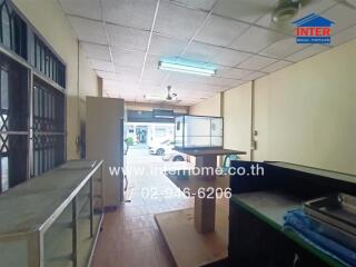 Interior space with large windows, tiled ceiling, and furniture.