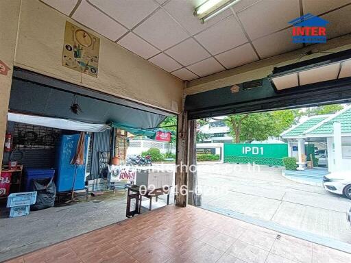 Street view of a building with open garage shutters