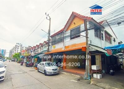 Street view of a building with multiple businesses and residential units