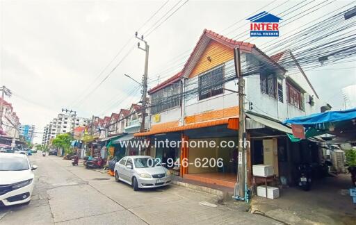 Street view of a building with multiple businesses and residential units