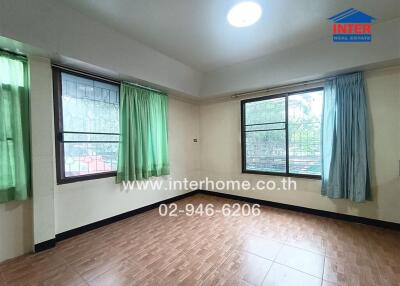 Empty bedroom with windows and tile flooring