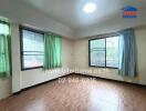 Empty bedroom with windows and tile flooring