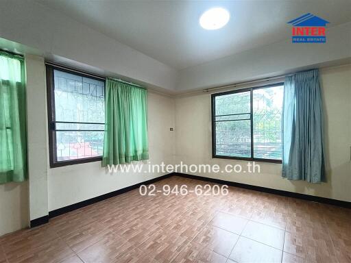 Empty bedroom with windows and tile flooring