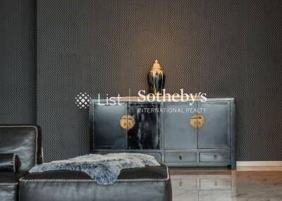 Modern living room with black leather furniture and decorative cabinet