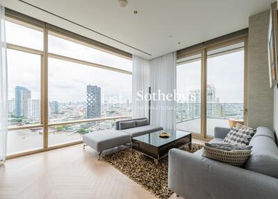 Modern living room with large windows offering city views