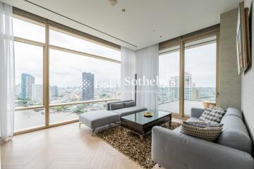 Modern living room with large windows offering city views