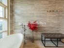 Modern bathroom with freestanding bathtub and red plant