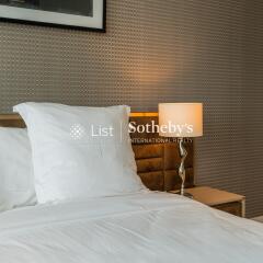 Bedroom with bedside lamp and patterned wallpaper