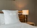 Bedroom with bedside lamp and patterned wallpaper