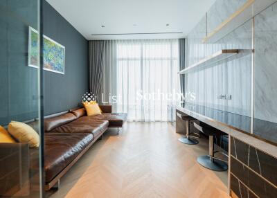 Modern living room with leather sofa and wall-mounted desk