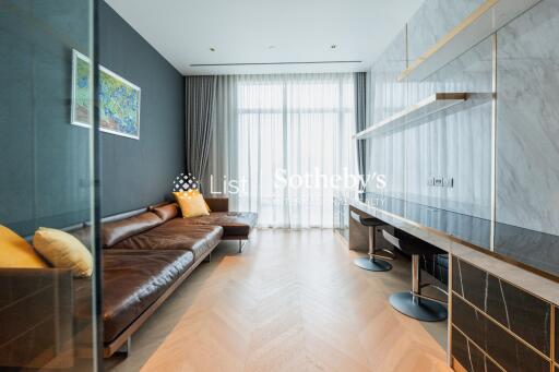 Modern living room with leather sofa and wall-mounted desk