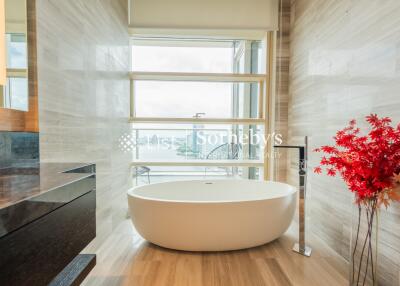 Modern bathroom with a freestanding bathtub and large window