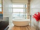 Modern bathroom with a freestanding bathtub and large window