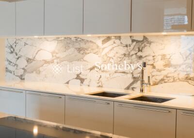 Modern kitchen with marble backsplash and sleek cabinetry