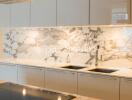 Modern kitchen with marble backsplash and sleek cabinetry