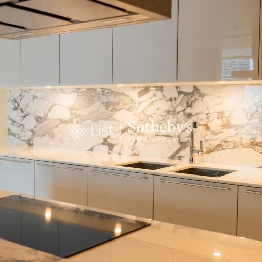 Modern kitchen with marble backsplash and sleek cabinetry