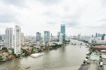 High view of a city with a river and multiple high-rise buildings