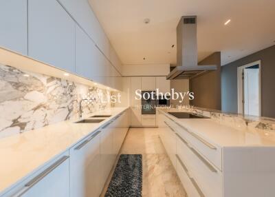 Modern kitchen with marble countertops and sleek white cabinetry