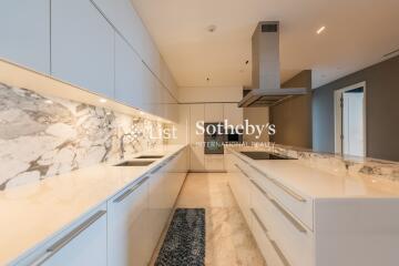 Modern kitchen with marble countertops and sleek white cabinetry