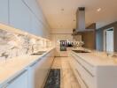 Modern kitchen with marble countertops and sleek white cabinetry