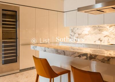 Modern kitchen with marble countertops and bar stools