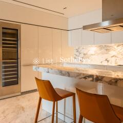 Modern kitchen with marble countertops and bar stools