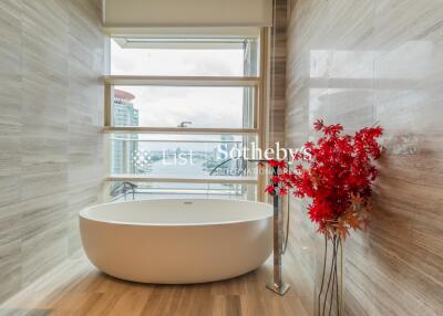 modern bathroom with a standalone bathtub and a city view