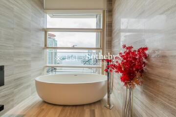 modern bathroom with a standalone bathtub and a city view