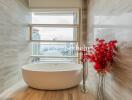 modern bathroom with a standalone bathtub and a city view