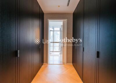 Modern hallway with dark wooden cabinets and a bright doorway