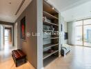 Modern living area with hallway and view of another room with large windows