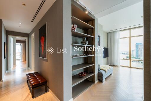 Modern living area with hallway and view of another room with large windows