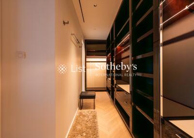 Modern dressing room with ample storage and lighting