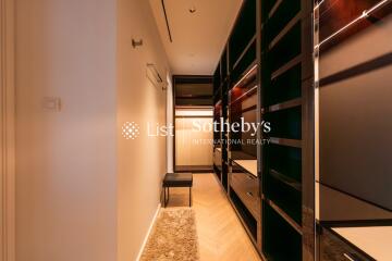 Modern dressing room with ample storage and lighting