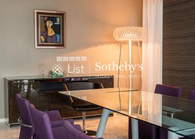 Modern dining room with purple chairs and glass table